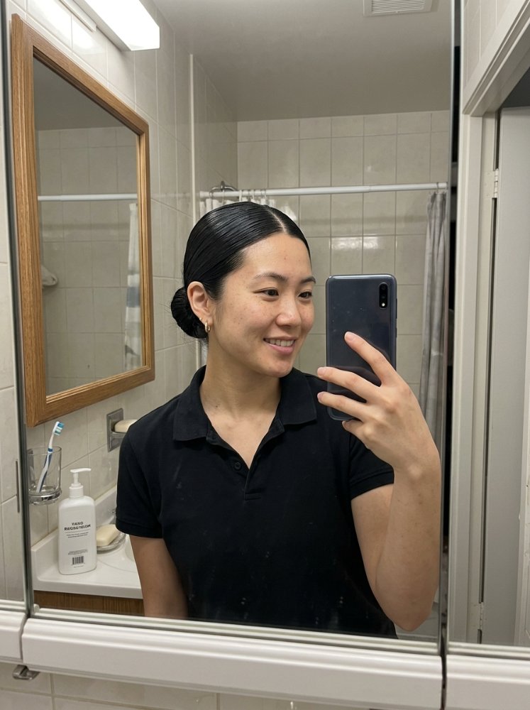 A with long, straight, black hair a black and taking a a