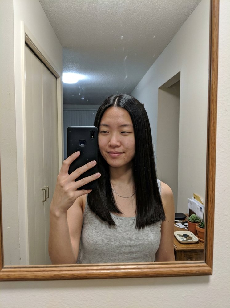 long straight black hairstyle Long straight black hair with a sleek glossy finish and smooth texture for a natural hair style